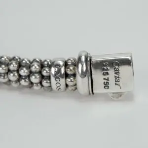 Silver beaded bracelet with engraved text.