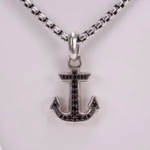 Anchor pendant on silver chain necklace.