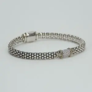 Silver beaded bracelet with decorative clasp.