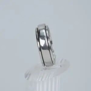 Silver ring on clear display stand.
