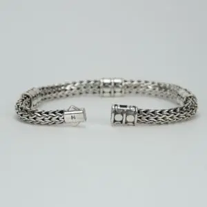 Silver woven bracelet with decorative clasps.