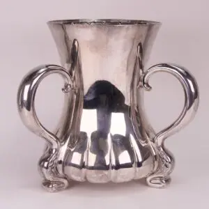 Silver decorative vase with two ornate handles.