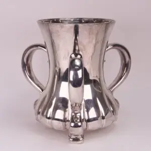 Silver cup with two handles and spout.
