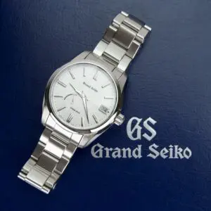 Grand Seiko watch on blue background.