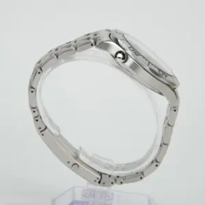 Silver wristwatch with metal strap, side view.
