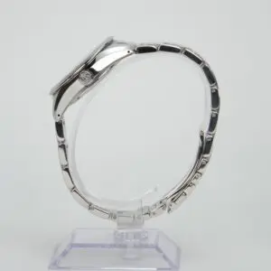 Side view of silver wristwatch on stand.