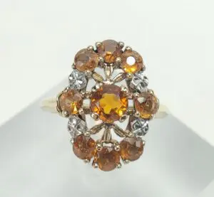 Gold ring with amber and clear stones.