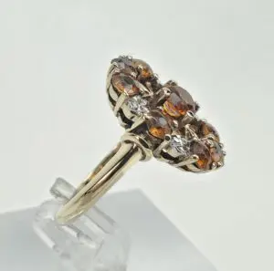 Gold ring with brown and white gemstones.
