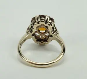 Gold ring with intricate gemstone setting.