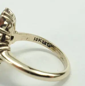 Gold ring with "18K" hallmark inside band.