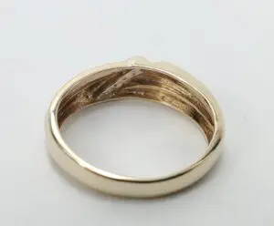 Gold ring with engraved details inside.