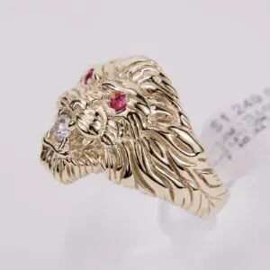 Gold lion head ring with gemstones.