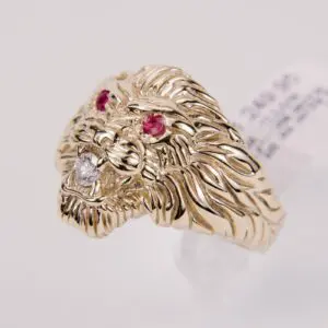 Gold lion ring with gemstone eyes.