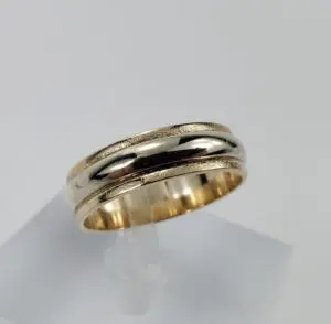 Gold band ring on display stand.