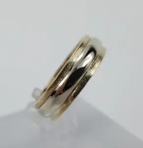 Gold and silver two-tone ring on display.