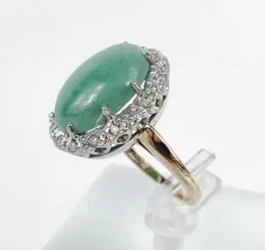 Gold ring with green stone and diamonds.