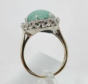 Gold ring with large green gemstone.