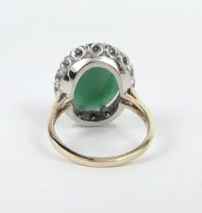Gold ring with green gemstone setting.