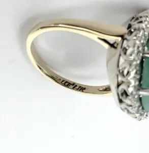 Gold ring with intricate gemstone setting.