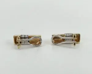 Gold and silver cufflink pair displayed.