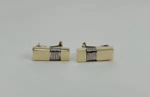 Gold cufflinks with black stripe design.