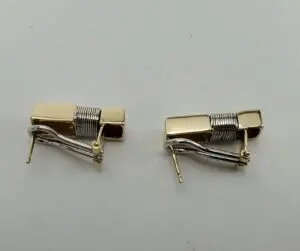 Gold and silver metal cufflinks on display.