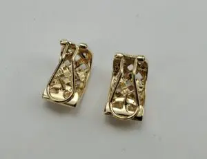 Gold earrings with intricate lattice design.