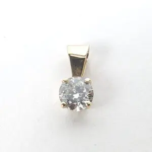 Gold pendant with a round diamond.
