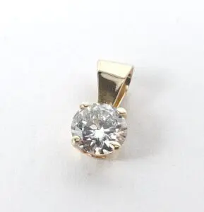 Gold pendant with a round diamond.
