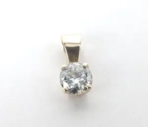 Gold pendant with a round diamond.