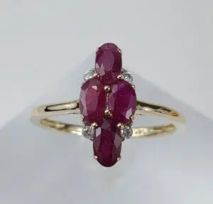 Gold ring with oval red gemstones.