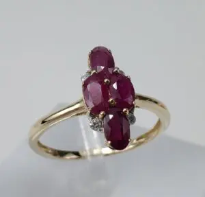 Gold ring with oval red gemstones.
