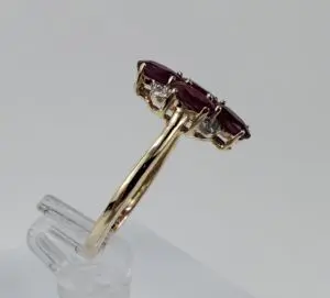 Gold ring with red and white stones.