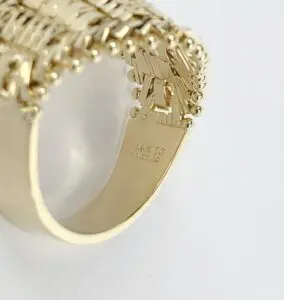 Gold ring with intricate woven design.