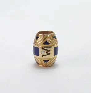 Gold and blue decorative bead with diamond.