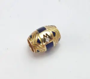 Gold and blue bead with diamond accent.