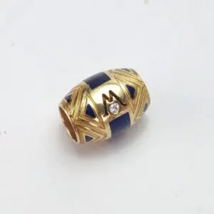 Gold and blue bead with diamond accent.