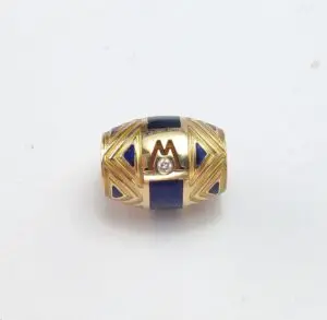 Gold bead with blue accents and diamond.