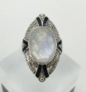 Silver ring with oval moonstone and details.