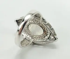 Silver ring with intricate geometric design.