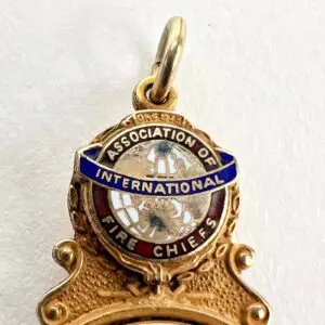 Gold badge of Association of International Fire Chiefs.