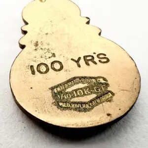 Gold pendant with "100 YRS" inscription.