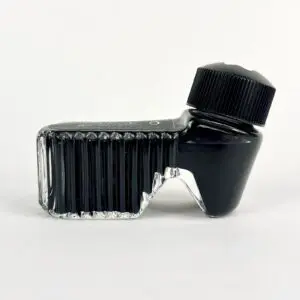 Unique black ink bottle with angled design.