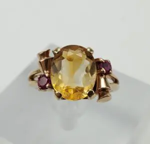 Gold ring with yellow and red gemstones.
