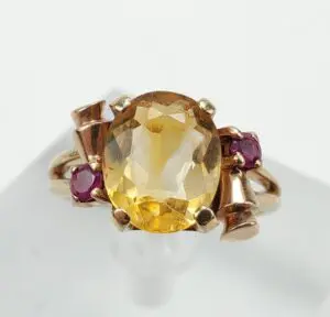 Gold ring with yellow and red stones.