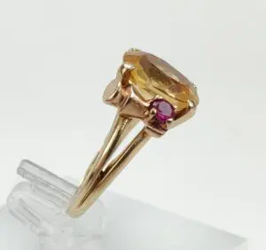 Gold ring with amber and pink stones.