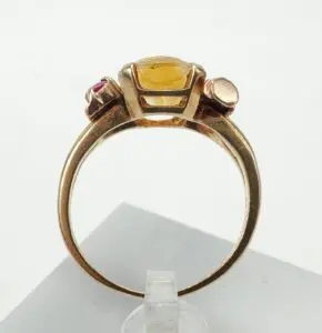 Gold ring with yellow and red gemstones.