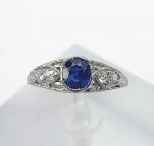 Silver ring with blue gemstone and diamonds.