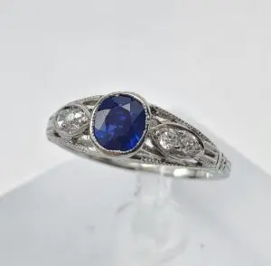 Silver ring with blue gemstone centerpiece.
