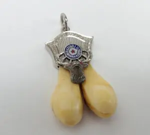 Silver pendant with two ivory tusk charms.